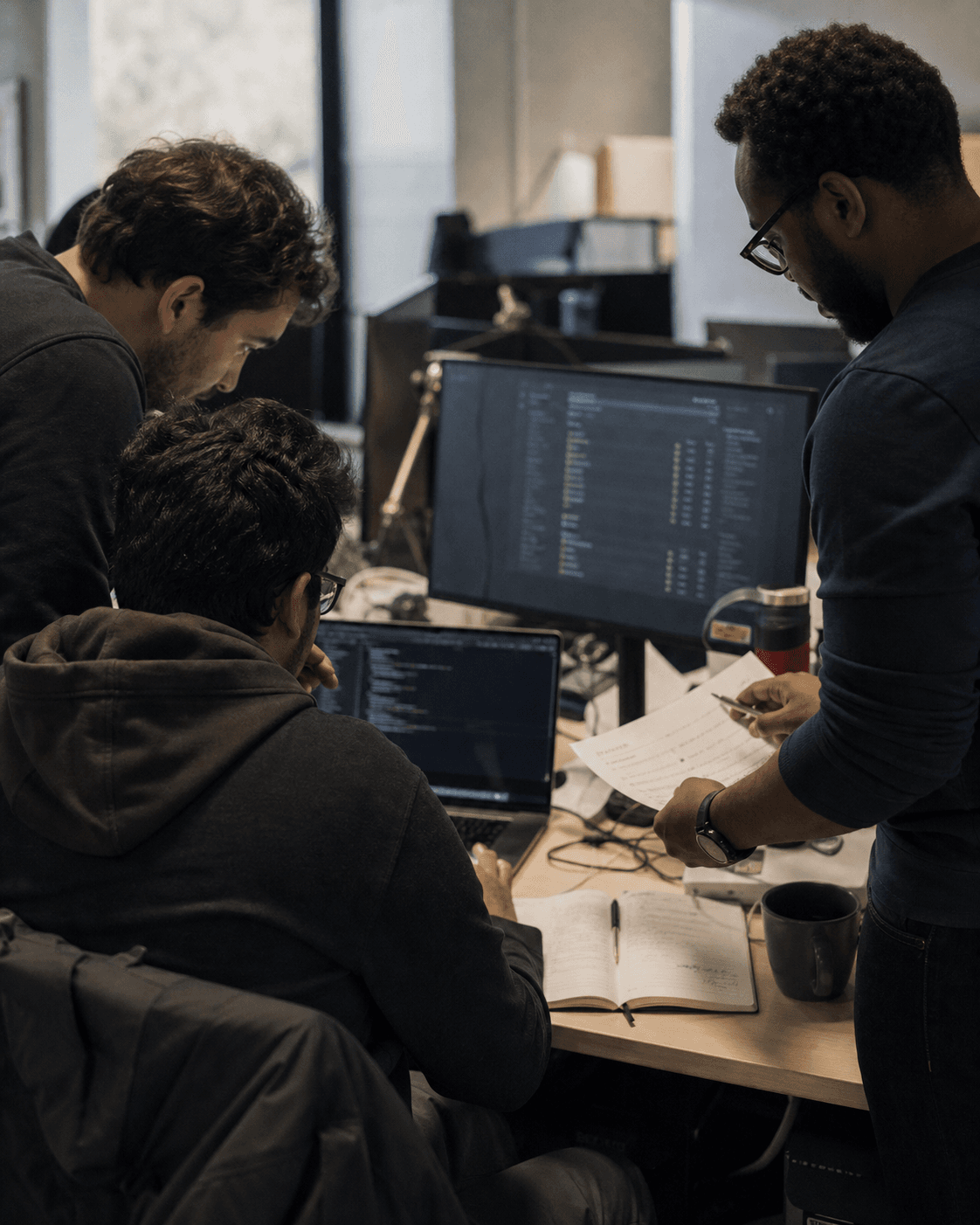 An engineering team reviewing code, tests, and release checks together.